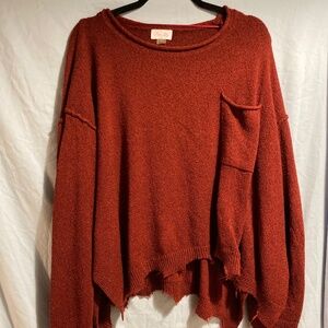 Red frayed sweater with front pocket